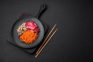 Delicious spicy mushrooms, carrots, cabbage sliced and cooked in Korean style photo