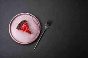 Beautiful tasty sweet slice of cheesecake with cherry on a ceramic plate photo