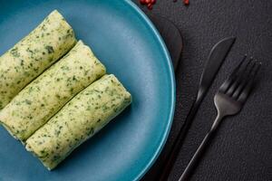 Delicious fresh pancakes with spinach, cream cheese, salmon, salt and spices photo