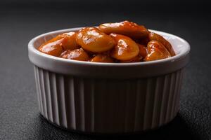 Delicious canned beans in a tomato in a round ceramic plate photo