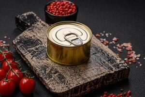 Round metal can with canned fish or meat with a key photo