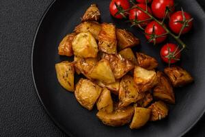 Delicious crispy fried potato wedges with salt, spices and herbs photo