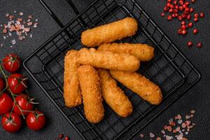 Delicious crispy cheese sticks with mozzarella, salt and spices, breaded photo