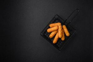 Delicious crispy cheese sticks with mozzarella, salt and spices, breaded photo