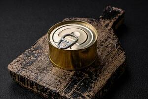 Round metal can with canned fish or meat with a key photo