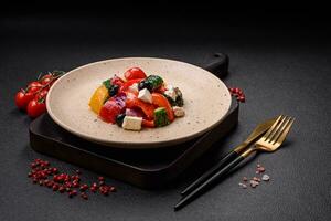 Delicious juicy Greek salad with feta cheese, olives, cucumber and tomatoes photo