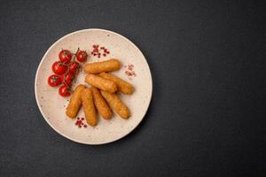 Delicious crispy cheese sticks with mozzarella, salt and spices, breaded photo