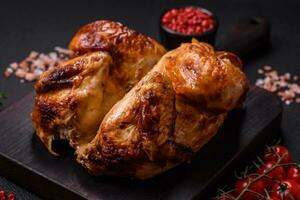 Crispy delicious whole baked chicken with vegetables, salt and spices photo