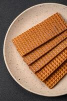 Delicious sweet crispy rectangular waffles on a ceramic plate photo