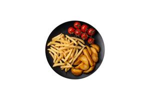 Fresh delicious crispy French fries with salt and spices photo