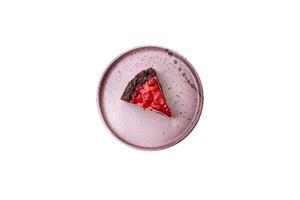 Beautiful tasty sweet slice of cheesecake with cherry on a ceramic plate photo