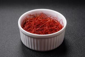 Red thin hot chili threads on a dark background photo