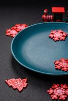 Ceramic round plate decorated with festive elements on the Christmas table photo