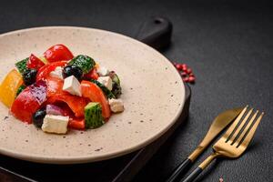 Delicious juicy Greek salad with feta cheese, olives, cucumber and tomatoes photo