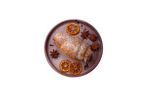 Delicious fresh sweet crispy croissants with chocolate cream on a ceramic plate photo