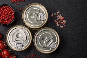 Round metal can with canned fish or meat with a key photo