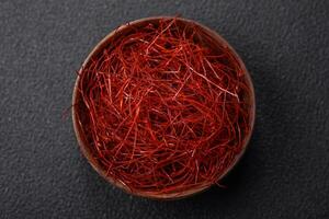 Red thin hot chili threads on a dark background photo