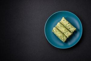 Delicious fresh pancakes with spinach, cream cheese, salmon, salt and spices photo