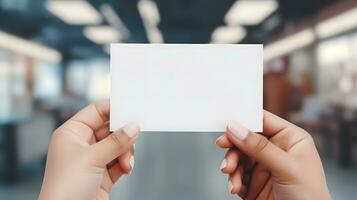 Female Hands Holding Blank White Business Card photo