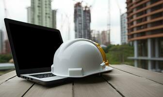 Laptop with hard hat and safety goggles on desk in construction office. Creating using generative AI tools photo