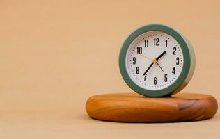 Alarm clock on plank, modern timepiece, precious time concept. Time planner. Working with limited time. photo