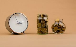 money and time saving money in a glass jar Saving money creates the future. Investment savings. Income. Investment. Cash flow. Coins. Money saving and financial investment concept photo