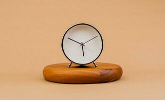 Modern alarm clock placed on a wooden plan Time clock, notifications, alarms time and work concept photo