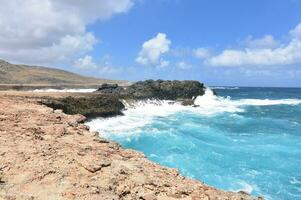 Tropical Waters Splashing Against the Coast in Aruba photo