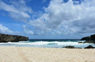 Desolate Caribbean Beach Under Thick Clouded Skies photo