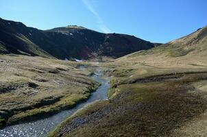 Steaming Hot Spring Stream in a Valley photo