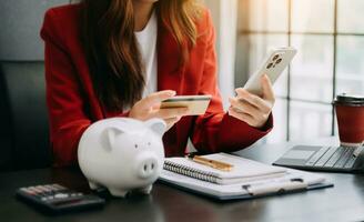 Business accountant working on desk using mobile phone and calculator to calculate budget concept finance and accounting photo