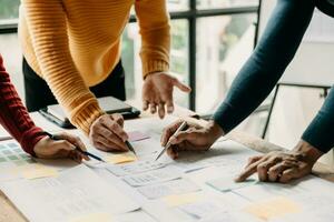 UX developer and ui designer brainstorming about mobile app interface wireframe design with customer breif and color code at modern office. photo