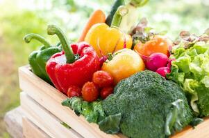 Wooden crate filled with fresh organic vegetables photo