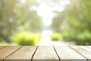 Empty wooden table with Blurred image of abstract circular green bokeh from nature style background. photo