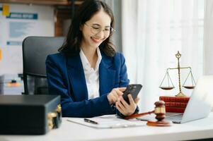 Beautiful woman lawyer working and gavel, tablet, laptop in front, Advice justice and law concept. photo