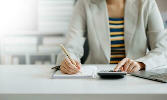 businesswoman hand working with new modern computer and writing on the notepad strategy diagram as concept photo