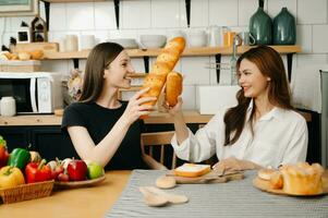 Image of newlywed couple cooking at home. Asia young couple cooking together with Bread and fruit in cozy kitchen photo