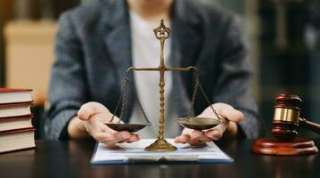 Male lawyer in the office with brass scale on wooden table. justice and law concept in morning light photo