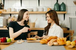 lovers or couples cooking in kitchen with full of ingredient with Bread and fruiton table.Valentines day and Sweet home. or Lesbian in love concept. photo