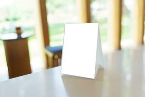 Mock up Menu frame standing on wood table in Bar restaurant cafe photo