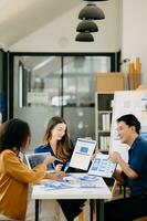 Team business people meeting in office. Employee brainstorm and work plan and discuss project by point on paper and tablet. photo