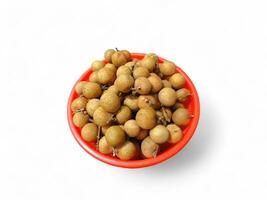 a red basket of longan fruit on a white background photo
