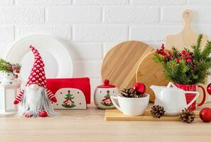 Chic kitchen background decorated with New Year's items, toys, dishes. White brick wall. Wooden countertop. Eco-friendly kitchen photo