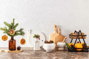 Stylish Christmas decor in the New Year's kitchen. Fragment of a countertop with modern decorations and kitchen utensils. Eco style. photo