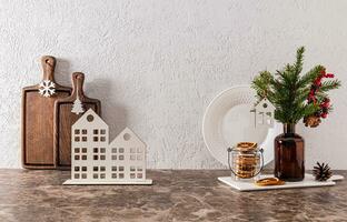 Stylish Christmas decor on a New Year's kitchen countertop made of stone. Beautiful New Year's style in minimalism. New Year's kitchen background. photo