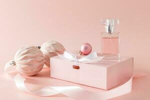 Beautiful New Year advertising composition with an elegant bottle of women's perfume standing on a gift box among pink Christmas balls. photo