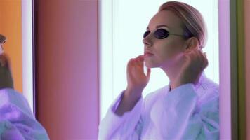Woman prepares for the tanning at the tanning booth video