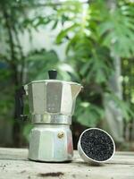 Moka pot coffee maker home drink small and good feel in garden and wooden table photo