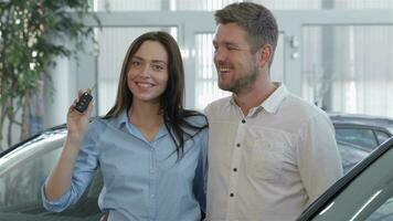 Couple enjoys the buying of car at the dealership video