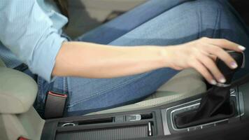 Woman holds her hand on the gear lever video